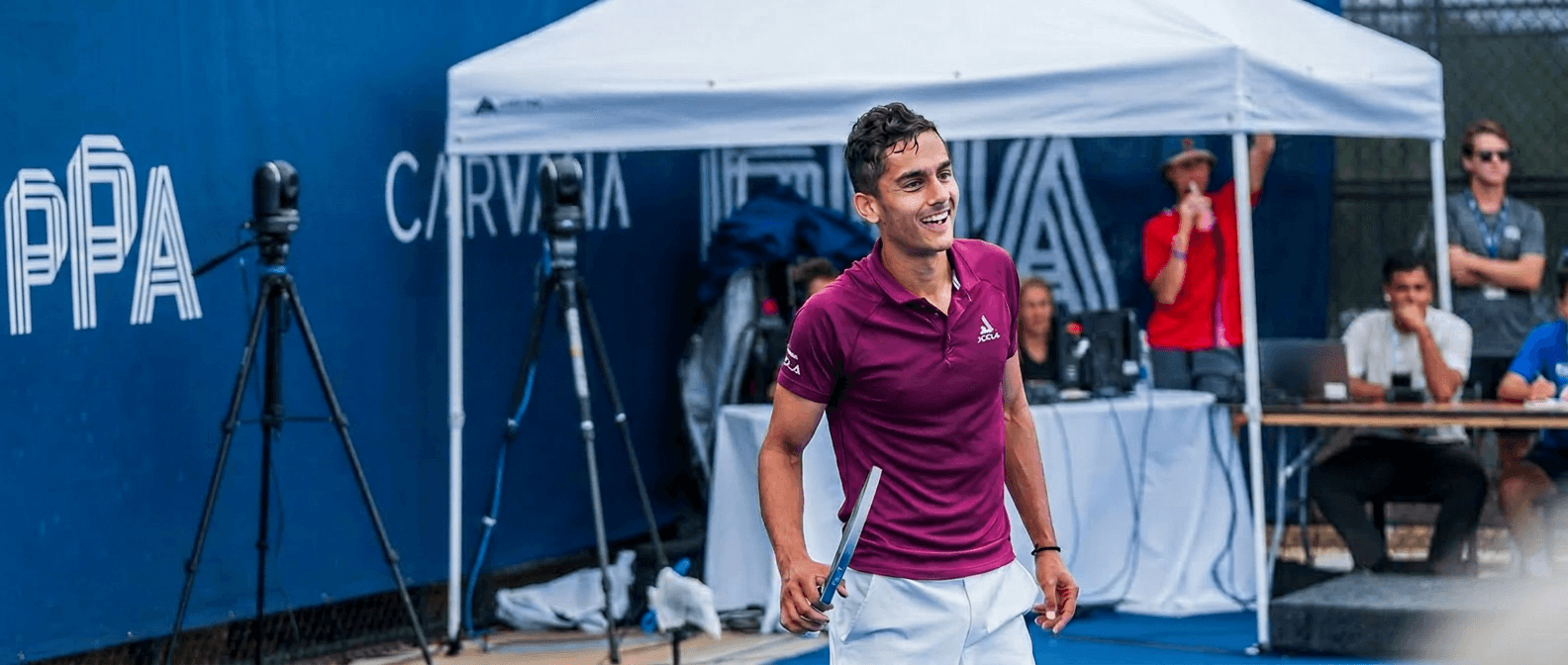 Aanik Lohani in a maroon JOOLA polo on court at a tournament